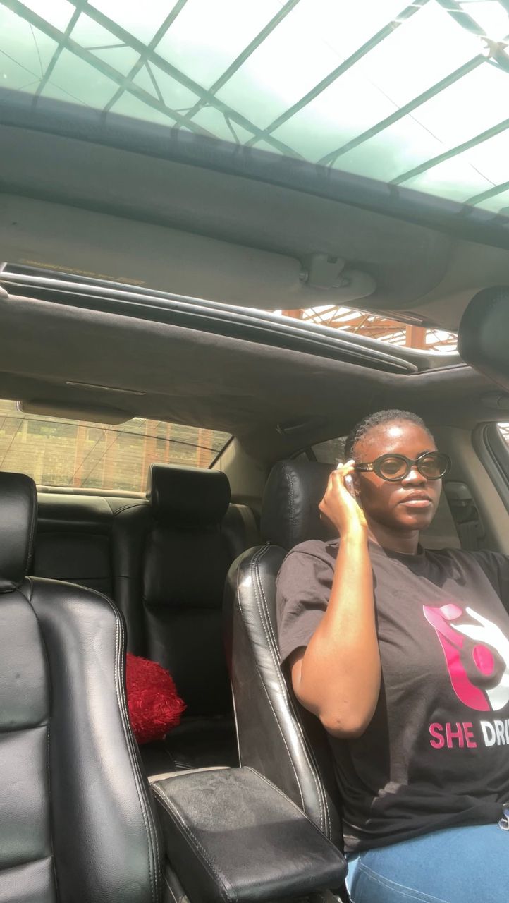 Female SheDrives driver seated in a car